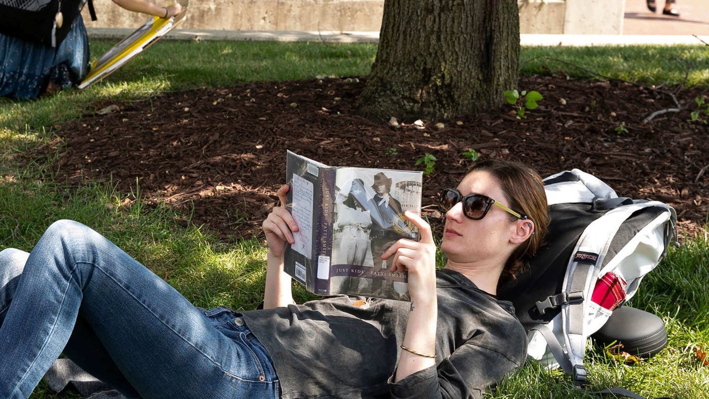 student-reading-outside-section-featured-240124